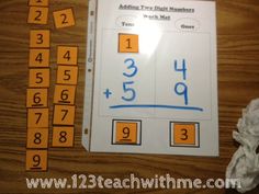 a table with some numbers on it and two pieces of paper next to the same number