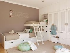 a bedroom with bunk beds and drawers in it