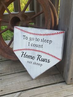 a wooden sign that says to go to sleep i count home runs not sheep