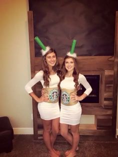 two girls dressed in starbucks costumes standing next to each other with their hands on their hipss