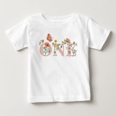 a white t - shirt with the word one written in flowers and a bird on it