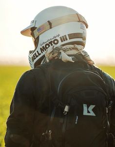 a person wearing a helmet and backpack in a field