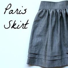 the skirt is made out of linen and has black lettering on it that says paris skt