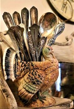 a turkey figurine with spoons and forks in it