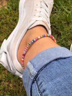 I love working with multi coloured vinyl disc beads. This one is made using 4mm African Vulcanite Vinyl Disc Beads. Mixed colours with the principal colour being pink and others include white, green, black, blue, red, orange & yellow disc beads. Your ankle bracelet will have these colours but not necessarily in the specific order of the ankle bracelet pictured. I put these disc beads on in any order. They are so tiny and fiddly I would be driven mad if I created a particular pattern I like the mixed up look not a formation. Hailing from the villages of West Africa, these brightly coloured discs are modelled after traditional Ghanaian Coconut Beads. Also known as African Vulcanite beads because they were originally made from vulcanized rubber, now they are more commonly made from using recy Beach Jewellery, Vinyl Disc, Surf Jewelry, Silver Ankle Bracelet, Beading Cord, Anklets Boho, Bohemian Jewellery, Chakra Jewelry, Surf Style