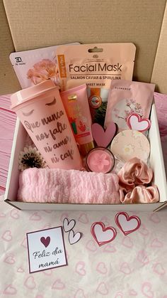 an open box containing personal care items on a pink table cloth with hearts around it