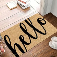 a door mat with the word hello on it next to two shoes and a book