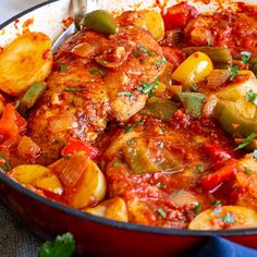 a pan filled with chicken and vegetables on top of a table