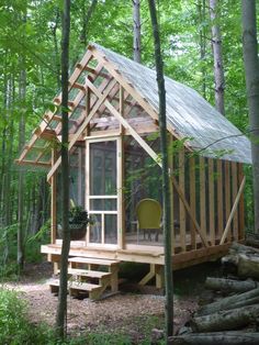 a small wooden cabin in the woods surrounded by trees