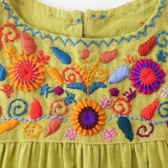 Our colorful Jardinita dresses are made of cotton are hand-embroidered making each one unique! Dresses are sleeveless and come with a button and loop on the back of neckline to secure. - available in sizes 0-4, 6 & 8 see size chart for measurements - as these are all one of a kind embroidery, color may differ from photo - washing in cold water + hang dry recommended - Made in Guatemala Sleeveless Summer Dresses With Geometric Embroidery, Bohemian Embroidered Sleeveless Sundress, Traditional Sleeveless Cotton Embroidered Dress, Traditional Sleeveless Embroidered Cotton Dress, Traditional Green Sleeveless Dress, Bohemian Green Dress With Embroidered Neckline, Sleeveless Cotton Embroidered Dress With Embroidered Hem, Green Bohemian Dress With Embroidered Hem, Bohemian Green Dress With Embroidered Hem