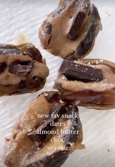 four chocolate covered donuts sitting on top of a white paper towel with words above them