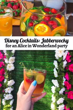 a woman holding up a drink with strawberries and lemons on the table next to flowers