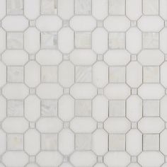 a white tiled wall with hexagonal tiles