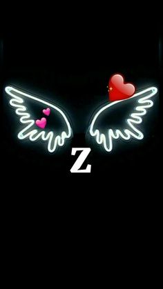 two hearts with wings and the letter z on them are lit up in the dark