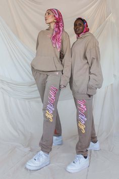 Playful floral motifs and hand drawn calligraphy complete the look of these comfortable pants. In a cotton tan fabric with a stretch waistband, you’re sure to fall in love. Designed in collaboration with beloved Artist @KweenKaraza Ammar (on the left) is a US size 6 and wearing M hoodie and M pants Fathia (on the right) is a US size 8 and wearing a L hoodie and L pants ALL apparel are final sale Hand Drawn Calligraphy, Streetwear Photoshoot, Tan Hoodie, Cold Culture, Hijabi Fits, Powerful Woman, Tan Fabric, Loungewear Outfits, Comfortable Pants