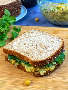 there is a sandwich on the cutting board