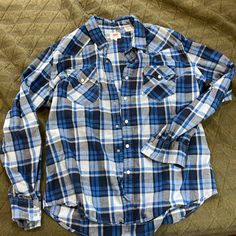 Levi’s Flannel With Snap Buttons Size Xl Never Worn But No Tags Levi's Casual Button-up Tops, Blue Long Sleeve Flannel Shirt With Pockets, Blue Flannel Shirt With Pockets, Levi's Blue Tops With Pockets, Levi's Casual Button Tops, Casual Levi's Shirt With Buttons, Casual Levi's Tops With Buttons, Blue Relaxed Fit Flannel Shirt With Pockets, Levi's Button-up Tops With Button Closure