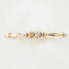 This dainty birthstone stackable ring is unlike any other, the band has a unique design all around which gives a bit of an antique feel. The perfect birthstone gift for your loved ones. Write out the two birthstones of your choice in the personalization box Two genuine 1.5mm gemstones Band width: approx. 1.75mm Material: 14k solid gold, rose gold, white gold Made of recycled precious metal and ethically sourced gemstone Packaged in a recyclable kraft ivory ring box <> January: Rhodolite Garnet F Birthstone Band, Ivory Ring, April Birthstone Ring, Stackable Birthstone Rings, Family Ring, January Birthstone Rings, Birthstone Rings, Family Rings, Stack Ring