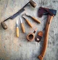 several different types of tools are laid out on the table together, including hammers and knives