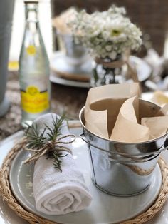 the table is set with dishes and napkins, including an old tin pail