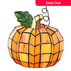 a stained glass pumpkin sitting on top of a white background with the words sold out