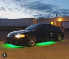 a black car with green lights on it