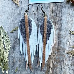 Leather feather earrings, soft layered white and textured upcycled leather, light weight and fabulous! Beautiful handmade leather feather earrings! These earring are handmade by artist Nadia Kuhl on Quadra Island ~ they are light weight and a total statement piece! They took a long journey into the light as they started as a jacket and have been up-cycled into a gorgeous piece of jewelry for the wild woman in your heart!   Whether you are getting ready for a night out, a wkd festival, and day at Handmade White Leather Earrings, Leather Feather Earrings, Feather Fringe, Upcycled Leather, Long Journey, Wild Woman, Feather Earrings, Fringe Earrings, Leather Earrings