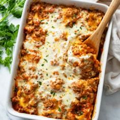 a casserole dish with meat, cheese and parmesan sauce in it