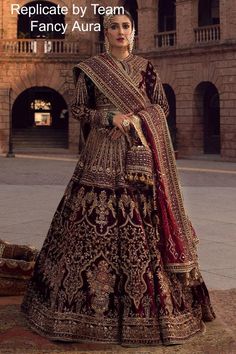 Kaif is our signature rich burgundy maroon colored bridal ensemble that will surely leave you spellbound with his impeccable design. It is adorned with luxurious embroidery that spans from hem to the neckline., the skirt features beautiful floral vases encased in symmetrical niches and accented with beautiful birds and vines.The bodice and sleeves featured intricate linear patterns, it is paired with coordinated marching diaphanous dupatta balancing the ensemble with simpler pairing featuring in Lehenga Choli Pakistani, Desi Attire, Floral Vases, Pakistani Bridal Dress, Dupatta Style, Velvet Lehenga, Bridal Dupatta, Party Kleidung, Pakistani Bridal Dresses