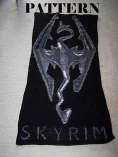 a black and silver knitted patch with the word skyrim on it's side