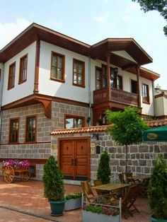 a large white and brown house with lots of windows