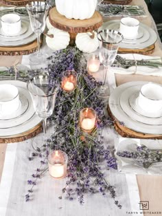 the table is set with candles and plates