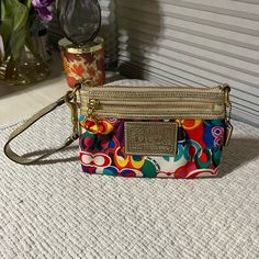 Coach Poppy Pop C Signature Multi-Color Clutchwristlet Bag #42898 - Multi-Color Fabric - Gold Leather - Blue Satin On The Inside - Multi-Function (Wristlet/Clutch) - (L) 7.5 X (H) 4.5 X (W) 1 Inches Coach Multicolor Pouch Wristlet, Coach Multicolor Travel Wristlet, Coach Multicolor Wristlet, Coach Multicolor Wristlet For Travel, Coach Multicolor Wristlet For Everyday, Multicolor Coach Wristlet For Travel, Multicolor Coach Wristlet For Daily Use, Coach Legacy, Coach Poppy