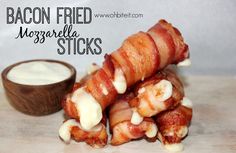 bacon fried mozzarella sticks are stacked on top of each other next to a small bowl of ranch dressing