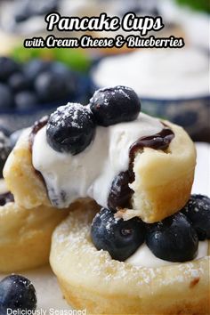 blueberry pancakes with cream cheese and blueberries are stacked on top of each other