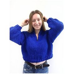 a woman wearing a blue sweater is posing for the camera with her hands on her head