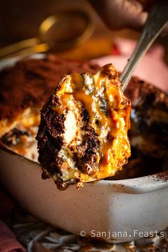 a close up of a piece of food in a bowl with a spoon on it