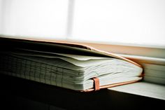 an open book sitting on top of a window sill