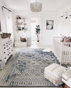 a baby's room with a crib and dresser