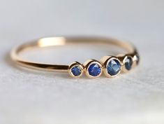 Blue sapphire ring, Blue sapphire stacking ring, dainty ring, stacking ring, stackable ring, blue sapphire ring, Sapphire ring Available in 9k/14k/18k yellow, rose or white gold. Same design can be made also with other custom gemstones per request. Product details: - Solid gold - approx 2.5, 2, 1.5 mm sapphire round - Band size is 1.2mm Ring size - US 3 to US 9 (for smaller or larger ring size, please contact) Please select your size at the drop down menu. Service Available - Customization Avail London Topaz Ring, London Topaz, Ring Blue Sapphire, Blue Sapphire Jewelry, Blue Topaz Jewelry, Ring Sapphire, Sapphire Band, Blue Sapphire Ring, Topaz Jewelry