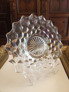 a glass bowl sitting on top of a table