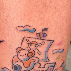 a drawing on the leg of a man with a teddy bear sitting in a car