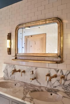 a bathroom vanity with two sinks and a large mirror