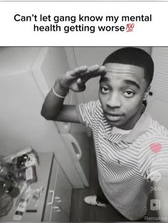 a black and white photo of a man in the bathroom with his hand on his head