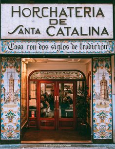 the entrance to an italian restaurant with tiled walls and doors that read, horchateria anta catalina