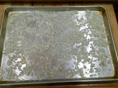 a metal pan filled with rice on top of a wooden table