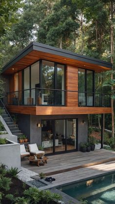 a modern house in the woods with stairs leading up to it's upper level