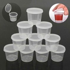 plastic cups with lids and spoons are stacked on top of each other in order to be filled