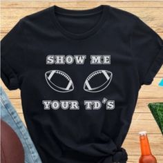 T-Shirt Colors Available : - Black - Navy Blue Sizes Available: - S - M - L - Xl Get Ready To Score Some Laughs With Our Exclusive Funny Football T-Shirt. The Shirt Features A Bold And Humorous Design That Reads "Show Me Your Td's" - A Play On The Phrase "Show Me Your T's" (Meaning "Show Me Your Toughness"). Whether You're A Fan Of The Nfl, College Football, Or Just Love The Game, This Shirt Is The Perfect Way To Show Off Your Sense Of Humor On Game Day. Made With High-Quality Materials And Craf Cricut Football Shirts Kids, Trendy Black Tops For Game Day, Game Day Graphic Tee With Slogan, Game Day Slogan Graphic Tee, Graphic Tee With Slogan For Game Day, Game Day Graphic Tee With Funny Print, Team Spirit Slogan Short Sleeve Tops, Funny Print Crew Neck Top For Game Day, Crew Neck Tops With Funny Print For Game Day