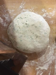 a ball of dough sitting on top of a wooden table